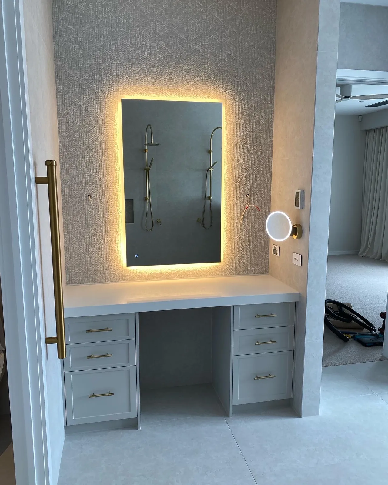 Bathroom vanity station with backlit mirror, joinery drawers and walk-in shower