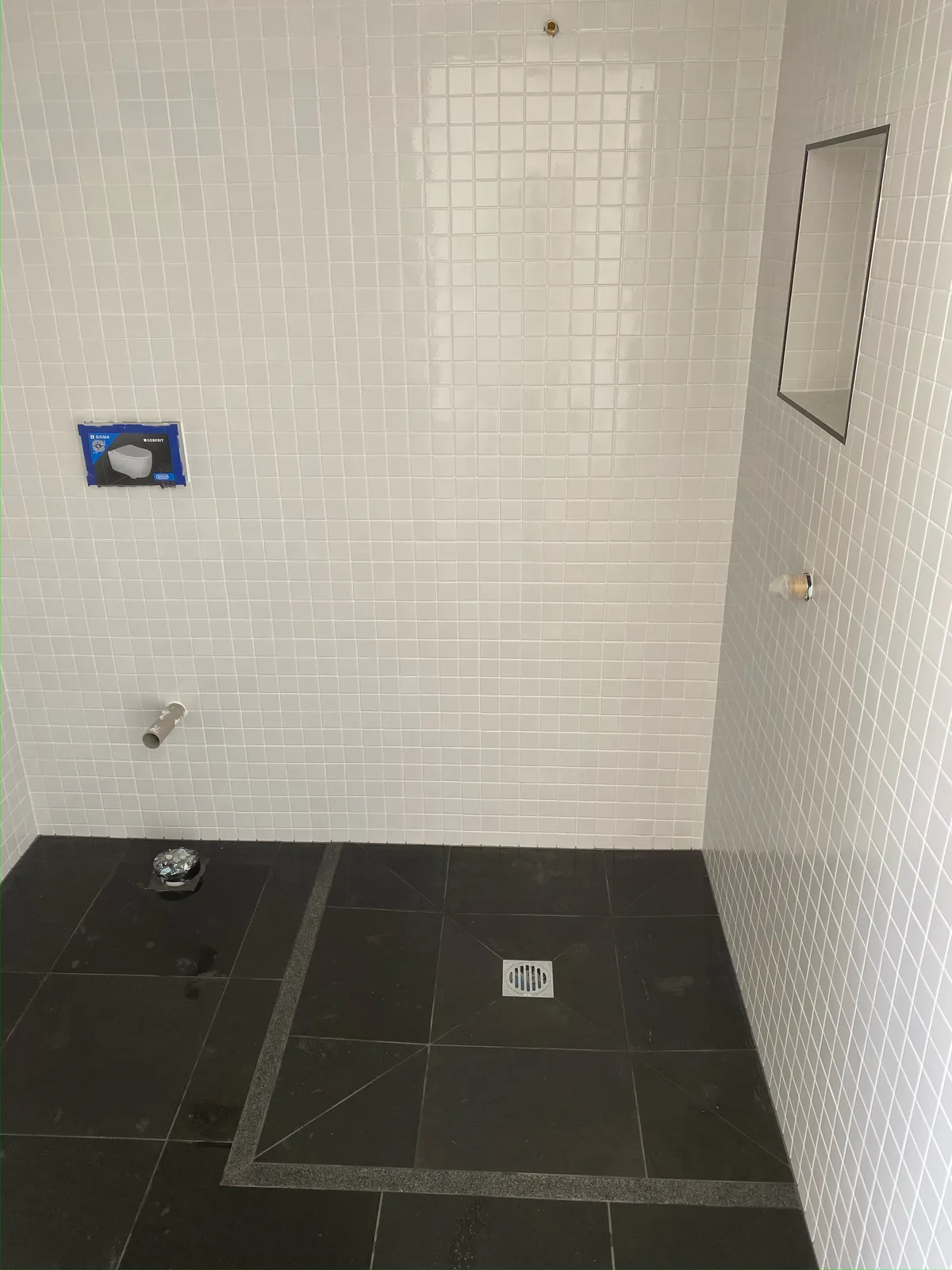 White glass mosaic wall tiling with black feature tile